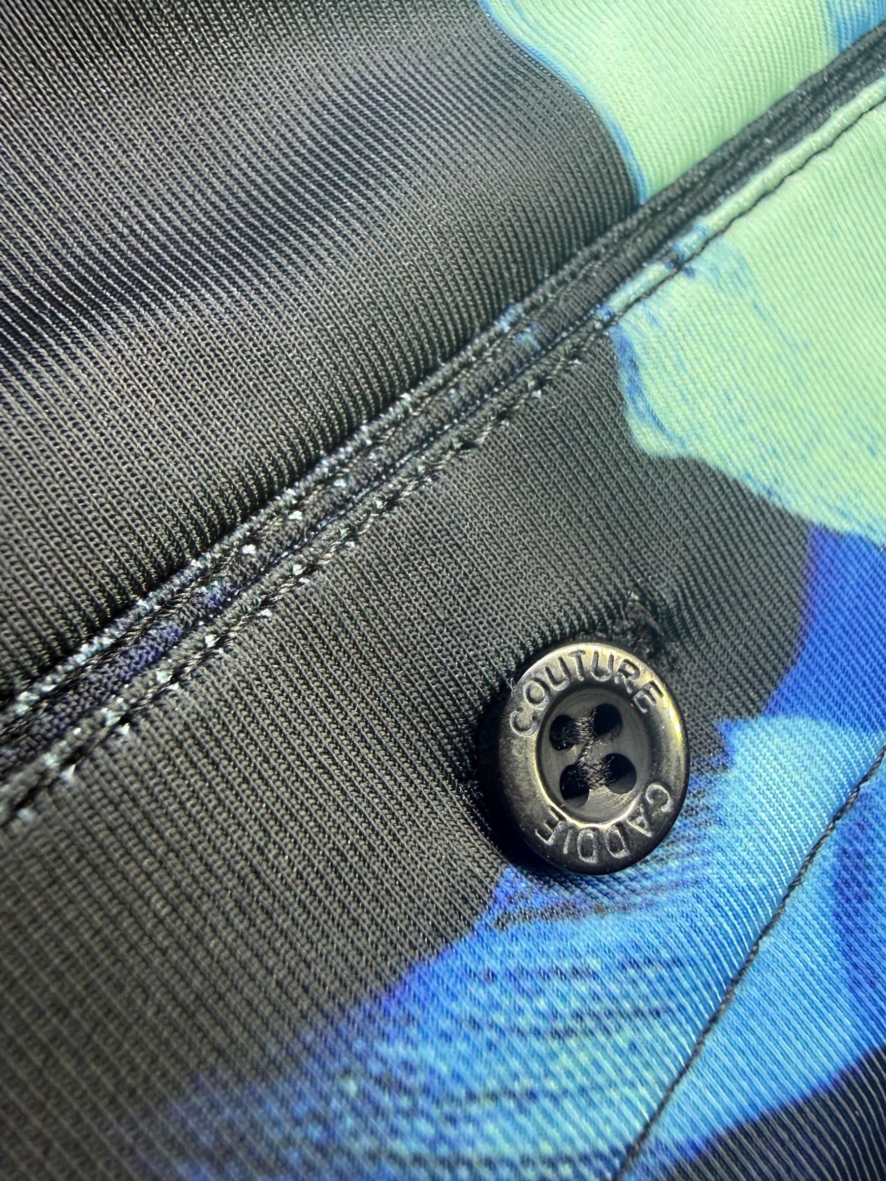 Close-up of a button on a multicolored fabric background