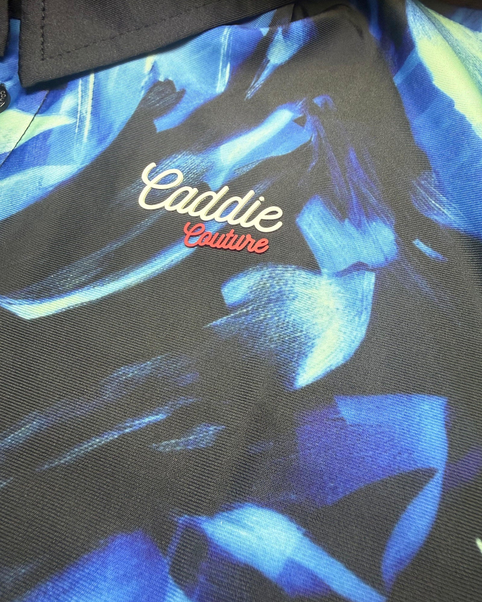 Close-up of Ocean Brush golf polo fabric, button and stitching