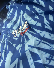 Close-up of a blue patterned fabric with a brand logo.