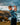 Young boy playing golf on a coastal cliff with ocean and sky in the background