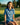 Young girl sitting on a stone wall in a golf course