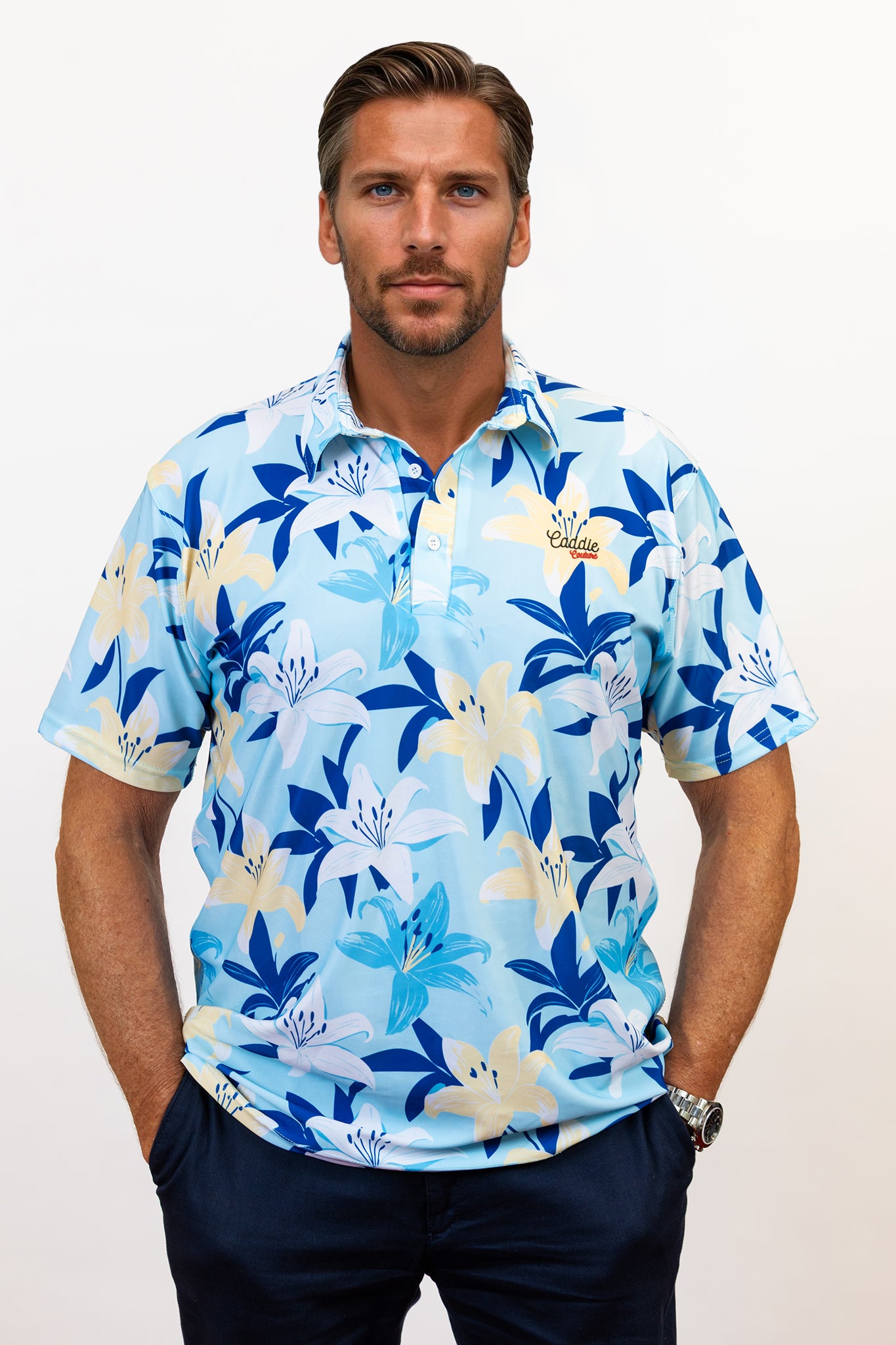 Man wearing a blue floral patterned golf shirt against a white background