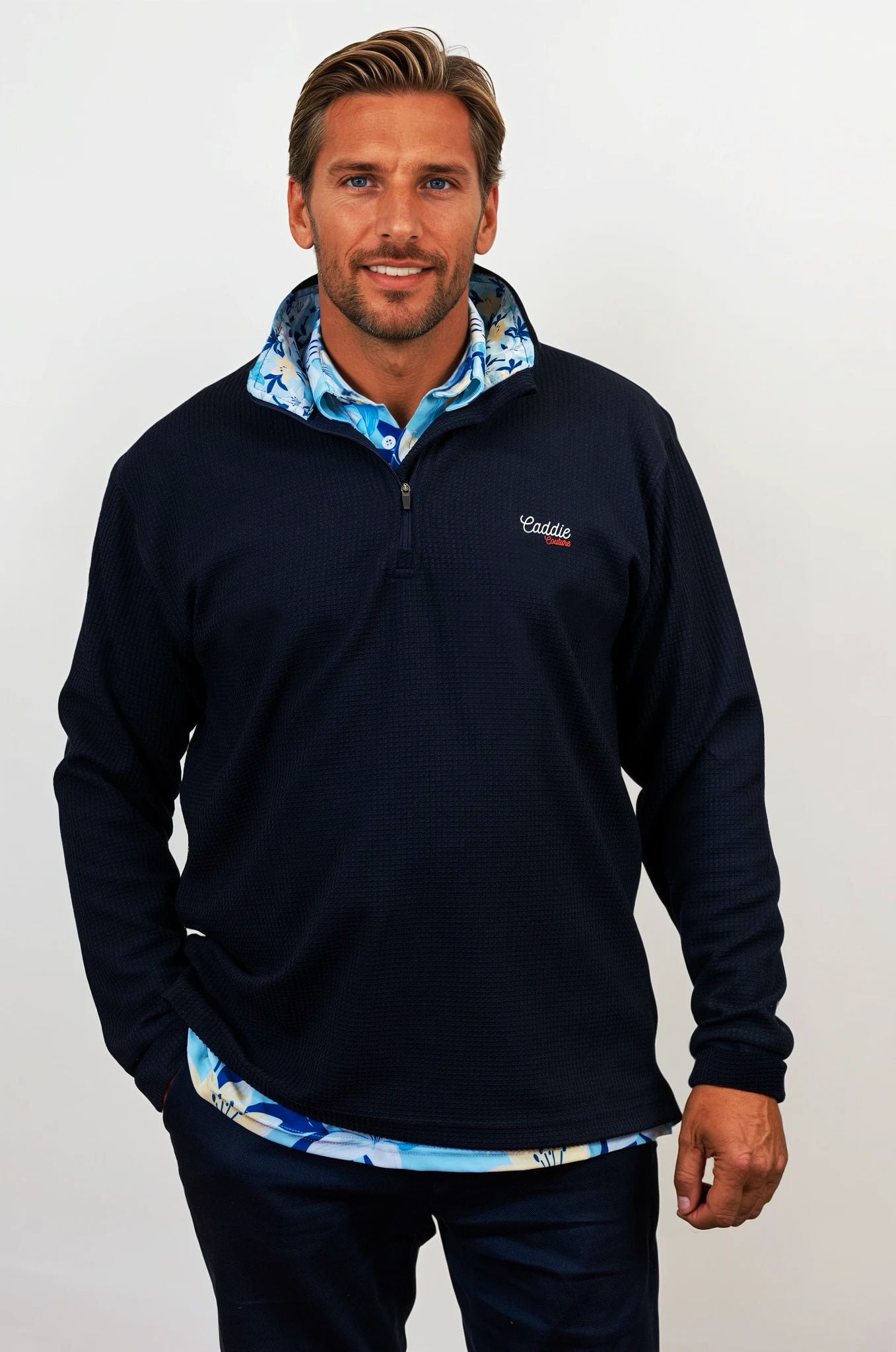 Man wearing golf quarter zip with floral pattern