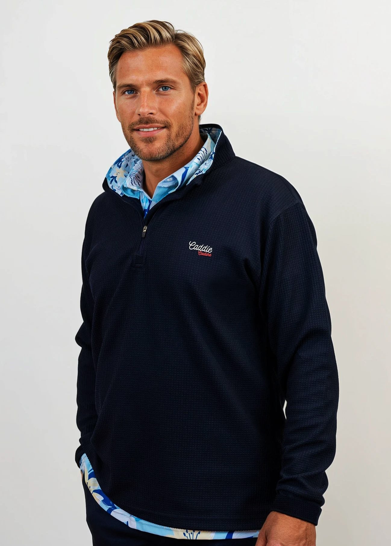 Man wearing golf quarter zip with floral pattern