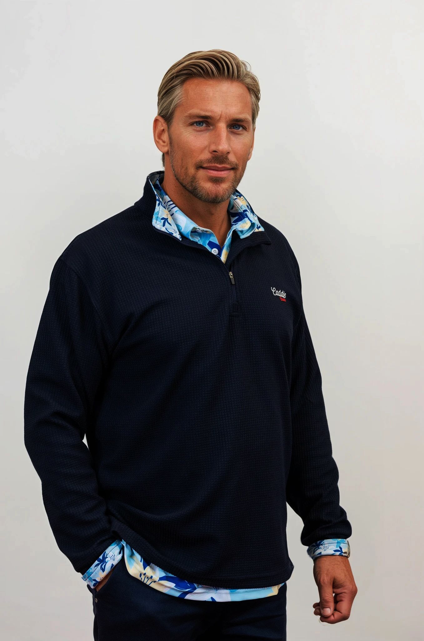 Man wearing golf quarter zip with floral pattern side view