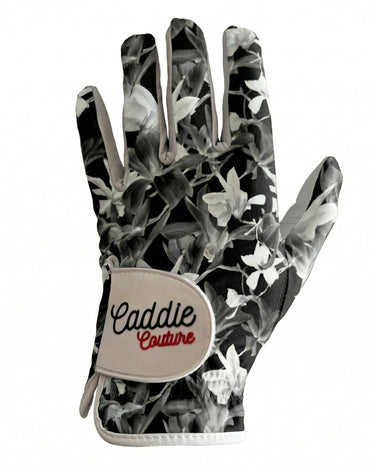 Golf glove with floral pattern and 'Caddie Couture' branding on a white background