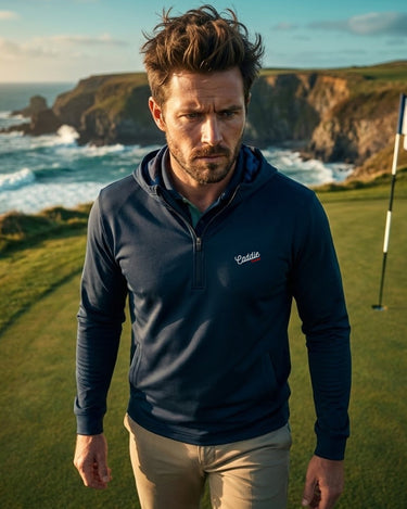 Man standing on a golf course with ocean and cliffs in the background