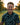 Man holding a golf club on a golf course with a blurred background