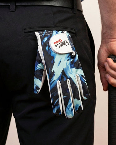 Caddie Couture Ocean Brush Golf Glove hanging out of a golfers back pocket