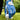 Golf glove with blue leaf pattern holding a golf ball on a tee, on a grassy background.