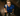 Man wearing blue floral polo in locker room from a Birdseye view