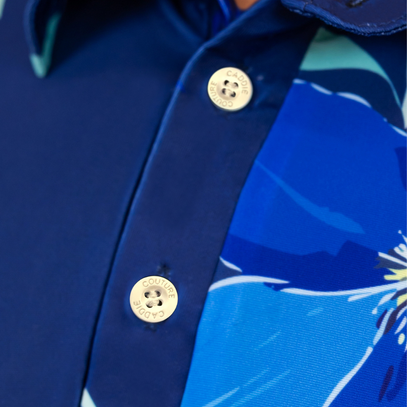 Close-up of a blue shirt with floral pattern and gold buttons