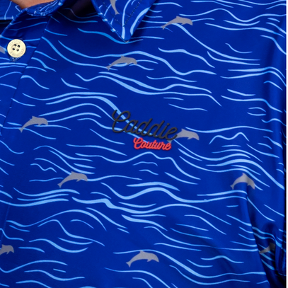 Blue polo shirt with wave pattern and 'Caddie Couture logo