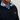 Navy pullover with a colorful collar and 'Caddie' logo on a light gray background