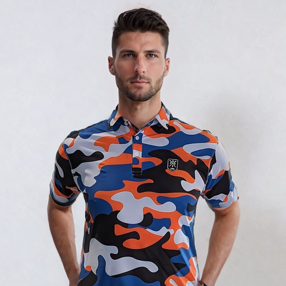 A man wearing a short-sleeved urban camo patterned golf polo shirt in blue, orange, and black colors.