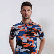 A man wearing a short-sleeved urban camo patterned golf polo shirt in blue, orange, and black colors.
