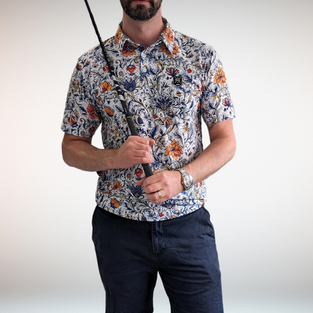 Man holding golf club wearing vintage floral golf polo shirt