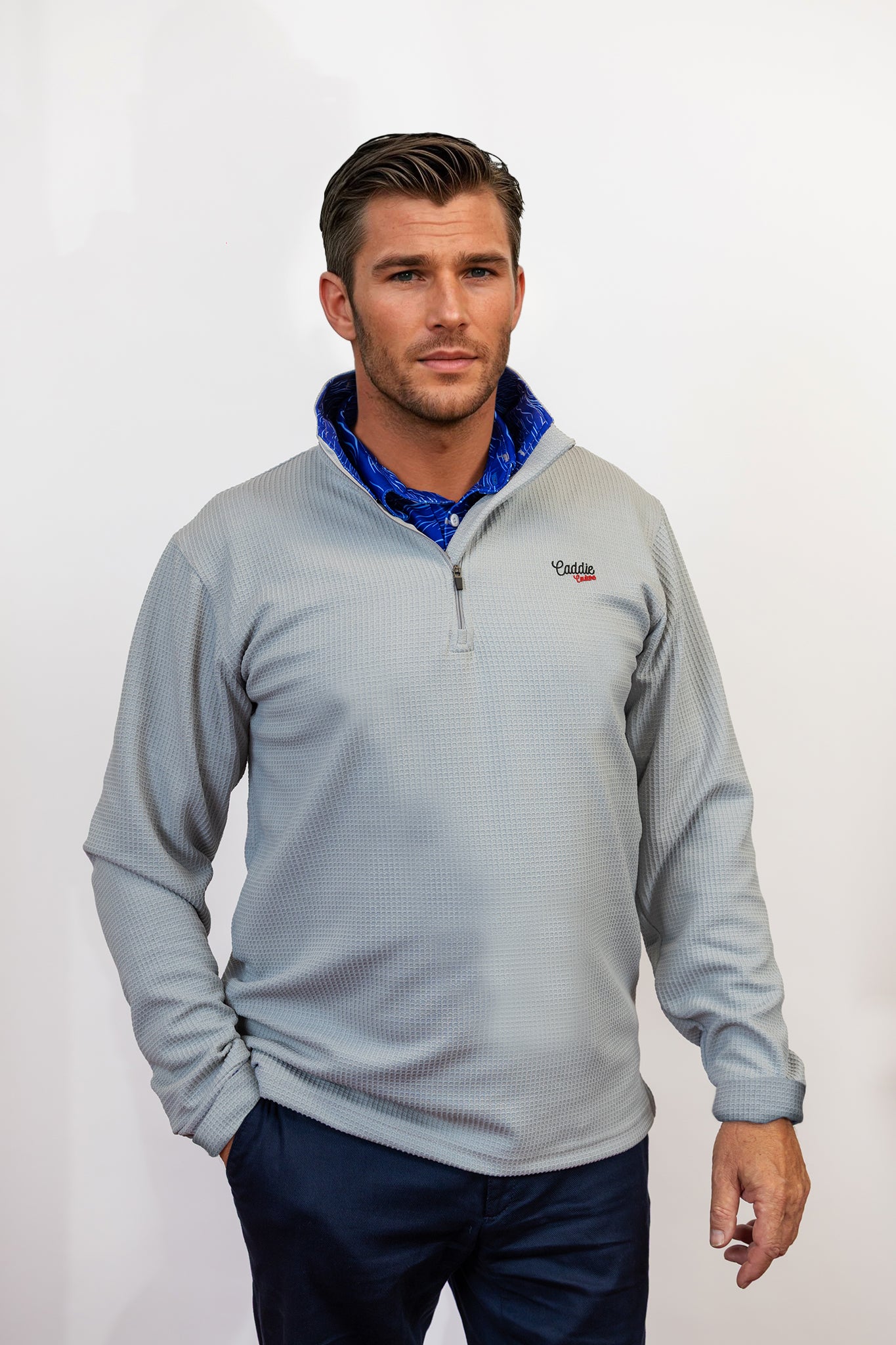Man wearing golf quarter zip with blue wave pattern in neck