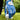 Golf glove with blue leaf pattern holding a golf ball on a tee, on a grassy background.