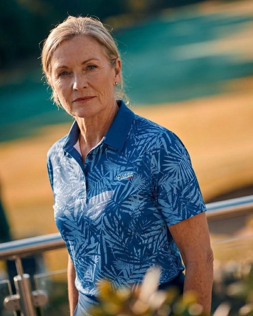 Woman wearing a blue patterned shirt standing outdoors with a blurred background