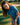 Young girl in a blue patterned outfit standing on a golf course