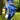 Blue floral golf glove on a golf ball with a blurred green background