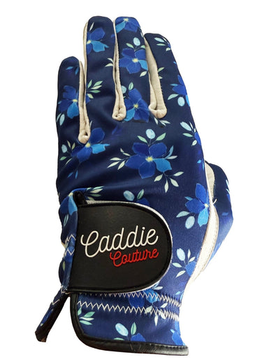Blue floral patterned golf glove with 'Caddie Couture' branding on a white background
