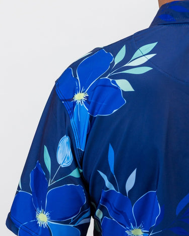 Blue floral golf shirt with a white background