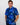 Man wearing a blue floral patterned golf shirt with a golf club on a white background