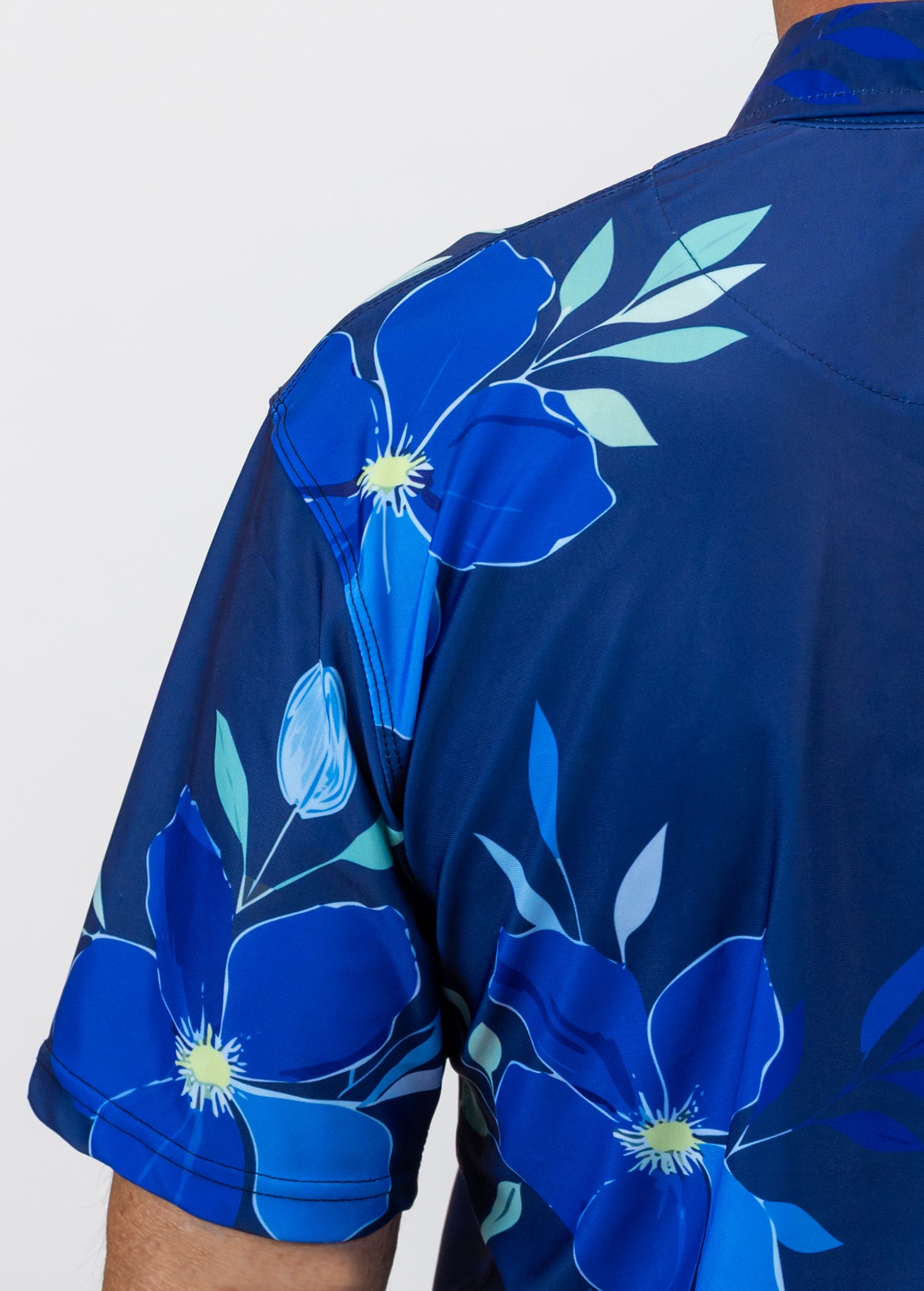 Blue floral golf shirt with a white background