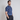 Model standing on his side wearing blue floral golf polo