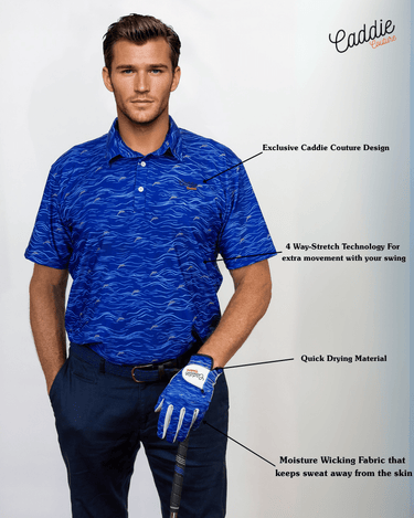 Man wearing a blue patterned golf shirt and navy pants with a golf club, on a light gray background.