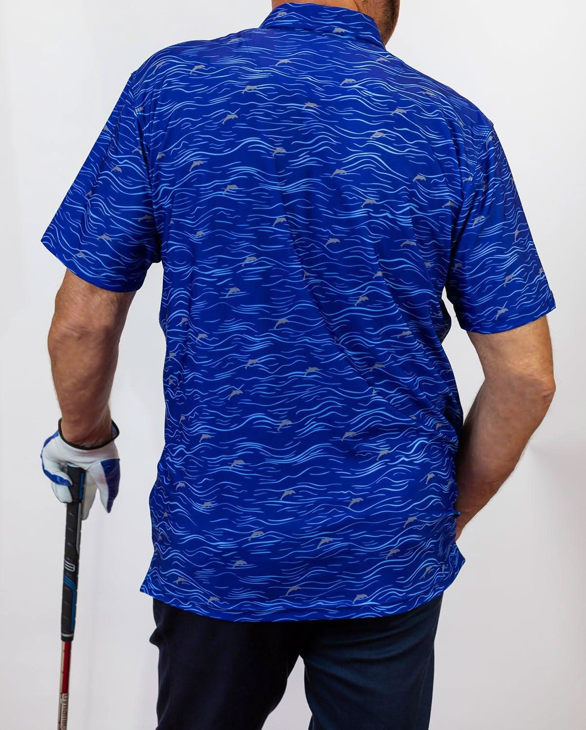 Person wearing a blue patterned golf shirt holding a golf club on a white background