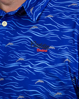 Blue polo shirt with wave pattern and 'Caddie Couture' logo
