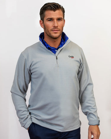 Man wearing golf quarter zip with blue wave pattern in neck