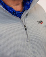 Man wearing golf quarter zip with blue wave pattern in neck