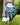 Golf glove with butterfly pattern holding a golf ball on grass