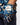 Golf glove with butterfly pattern worn by a person, against a blurred background