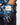 Golf glove with butterfly pattern worn by a person, against a blurred background