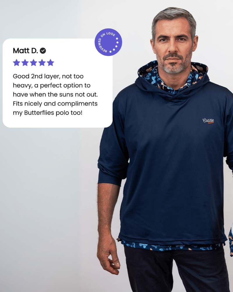 Man wearing a navy golf hoodie with a brand logo, standing against a plain background.