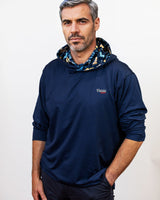 Man wearing a navy blue hoodie with a patterned hood against a white background