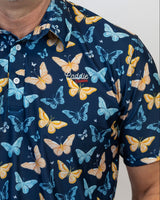 Navy blue Golf Polo with colourful butterfly pattern worn by a person
