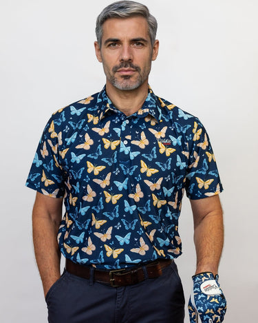 Man wearing a blue butterfly pattern shirt and glove, holding a golf club.