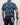 Person wearing a navy shirt with butterfly pattern, holding a golf club, on a plain background