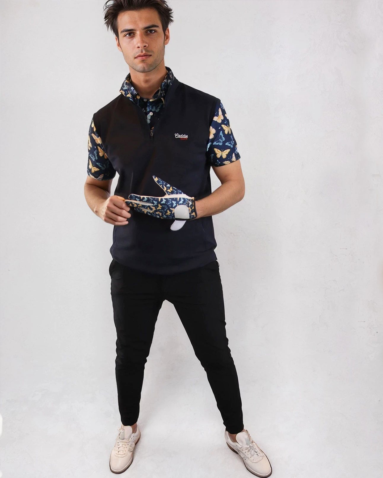 man wearing butterfly gilet and golf joggers 