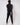 man with back to camera wearing black golf joggers