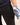 Person wearing a blue patterned glove on a plain background