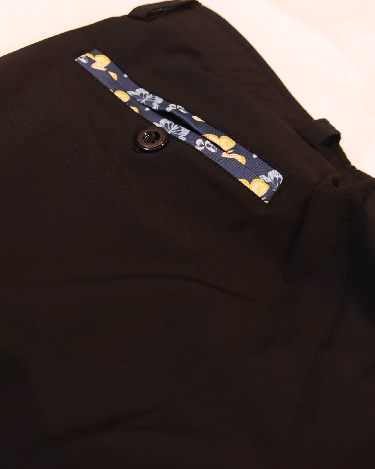 close up of golf joggers pocket with butterfly detailing