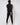 man with back to camera wearing black golf joggers