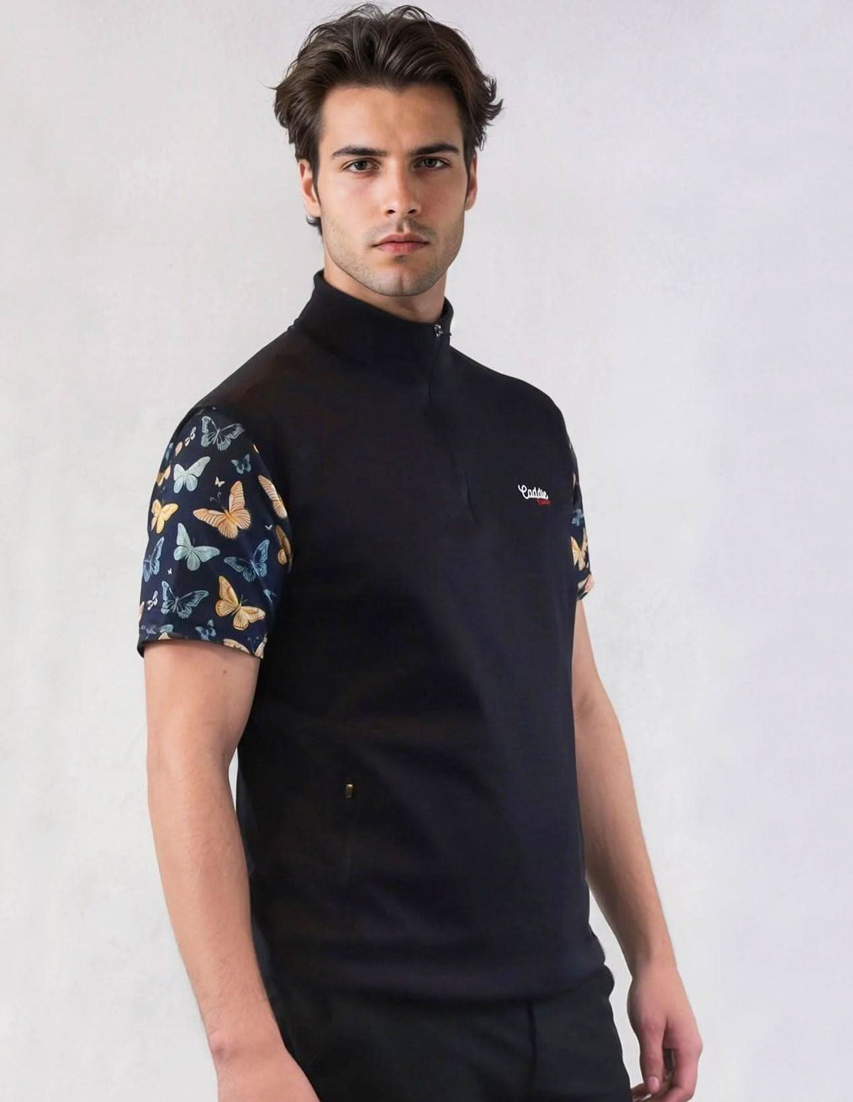 Man wearing a Navy golf vest with butterfly pattern sleeves on a white background